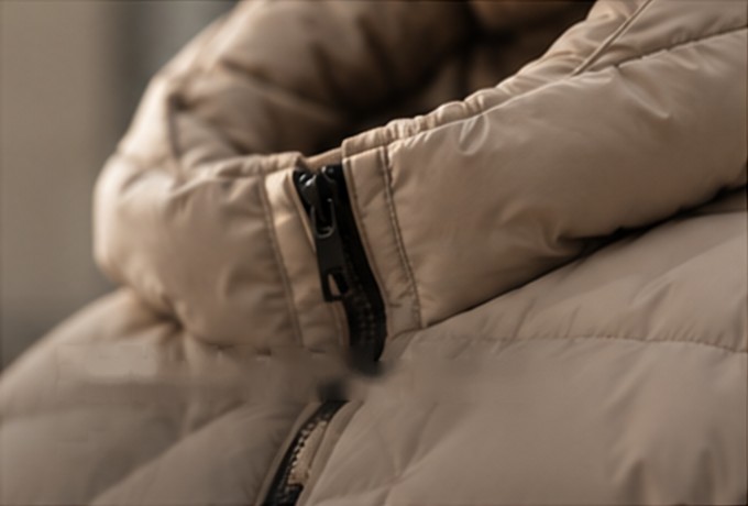 Detail of a beige padded puffer jacket